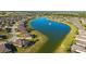 Stunning aerial view of homes surrounding a picturesque lake with a fountain feature in a well-planned community at 6558 Sw 94Th Cir, Ocala, FL 34481