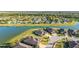 Lovely aerial view of lakeside homes featuring manicured lawns and beautiful water views in a serene neighborhood at 6558 Sw 94Th Cir, Ocala, FL 34481