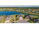 Picturesque aerial view of residences around a lake with lush landscaping in a peaceful, well-maintained neighborhood at 6558 Sw 94Th Cir, Ocala, FL 34481
