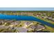 Scenic aerial view of beautiful homes bordering a tranquil lake with lush greenery in a desirable community setting at 6558 Sw 94Th Cir, Ocala, FL 34481