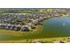 Aerial view of the community showcases homes situated along a scenic lake with lush surroundings at 6558 Sw 94Th Cir, Ocala, FL 34481