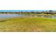 Expansive lush backyard overlooking a tranquil lake with neighborhood views at 6558 Sw 94Th Cir, Ocala, FL 34481