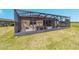 Exterior view of a screened in lanai, with a yard, overlooking a tranquil lake at 6558 Sw 94Th Cir, Ocala, FL 34481