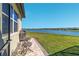 Charming backyard with a patio, comfortable seating, and serene lake views at 6558 Sw 94Th Cir, Ocala, FL 34481