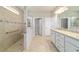 A bright bathroom featuring a large walk-in shower and a double sink vanity at 6558 Sw 94Th Cir, Ocala, FL 34481