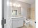 Bathroom featuring granite counters, tub with tile surround, and white shaker-style cabinets at 6558 Sw 94Th Cir, Ocala, FL 34481
