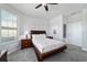Comfortable bedroom with soft carpet, ceiling fan, wooden furniture and an ensuite bath at 6558 Sw 94Th Cir, Ocala, FL 34481