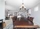 The dining room has chandelier lighting and is an open concept to the living room and kitchen at 6558 Sw 94Th Cir, Ocala, FL 34481