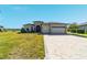Attractive home with a paved driveway, well-manicured lawn, and a convenient three-car garage, perfect for Gathering living at 6558 Sw 94Th Cir, Ocala, FL 34481