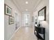 Open and airy foyer with neutral tones, decorative console table, and a view of the home's interior at 6558 Sw 94Th Cir, Ocala, FL 34481