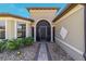 Charming home featuring a covered front entrance with decorative columns and meticulous landscaping at 6558 Sw 94Th Cir, Ocala, FL 34481