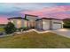 Attractive single-story home with a well-kept lawn, mature landscaping, and a spacious two-car garage at 6558 Sw 94Th Cir, Ocala, FL 34481