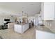 Spacious kitchen with center island, granite countertops, stainless appliances, and open layout to living area at 6558 Sw 94Th Cir, Ocala, FL 34481
