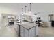 Gourmet kitchen with an oversized island, pendant lighting, and an open view to the living and dining area at 6558 Sw 94Th Cir, Ocala, FL 34481