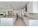 Modern kitchen featuring stainless steel appliances, an island, and ample counter space, open to the living area at 6558 Sw 94Th Cir, Ocala, FL 34481