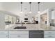 Open concept kitchen with stainless steel appliances, a sink, and pendant lighting in a modern design at 6558 Sw 94Th Cir, Ocala, FL 34481