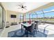 Relaxing screened-in lanai with comfortable seating, a ceiling fan, and scenic water views at 6558 Sw 94Th Cir, Ocala, FL 34481