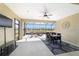 Enclosed lanai offers a serene dining space with tranquil lake views and comfortable seating at 6558 Sw 94Th Cir, Ocala, FL 34481