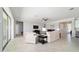 Bright living room features neutral furniture and decor, offering seamless access to other rooms at 6558 Sw 94Th Cir, Ocala, FL 34481