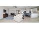 Expansive living space with tile flooring leading to a modern kitchen and adjacent dining space at 6558 Sw 94Th Cir, Ocala, FL 34481