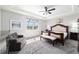 Main bedroom with abundant sunlight, decorative ceiling, and serene window views at 6558 Sw 94Th Cir, Ocala, FL 34481