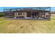 An exterior shot of the home’s screened patio featuring comfortable seating and a hot tub at 6558 Sw 94Th Cir, Ocala, FL 34481