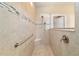 This shower has tile walls, a window, a seat, a shower head and grab bars at 6558 Sw 94Th Cir, Ocala, FL 34481