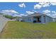 Covered patio and expansive backyard featuring well-maintained privacy fence at 6933 Se 111Th Ln, Belleview, FL 34420