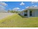 Backyard with covered patio, grill, and privacy fence providing a cozy outdoor living space at 6933 Se 111Th Ln, Belleview, FL 34420
