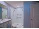 Bathroom with glass shower, single sink vanity, and blue accent walls at 6933 Se 111Th Ln, Belleview, FL 34420
