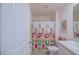 Bright bathroom with floral shower curtain and a clean, well-maintained vanity area at 6933 Se 111Th Ln, Belleview, FL 34420