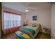 Well-lit bedroom features floral bedding, bright windows, and playful decor, including a surfboard accent at 6933 Se 111Th Ln, Belleview, FL 34420