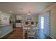 A dining area features sliding doors, a white table with six chairs, and decorative lighting at 6933 Se 111Th Ln, Belleview, FL 34420
