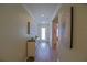Inviting foyer with console table, artwork, and hardwood flooring at 6933 Se 111Th Ln, Belleview, FL 34420