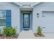 Close-up of a front door featuring decorative glass and manicured landscaping at 6933 Se 111Th Ln, Belleview, FL 34420