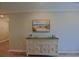 Hallway with a decorative cabinet featuring sea-themed accents, beachy artwork, and St. Patrick's day decor at 6933 Se 111Th Ln, Belleview, FL 34420