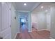 Hallway showcasing doorways leading to a living room and a laundry room, highlighting the floor plan at 6933 Se 111Th Ln, Belleview, FL 34420