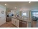 Open concept kitchen with granite countertops, stainless steel appliances, and adjacent dining area at 6933 Se 111Th Ln, Belleview, FL 34420