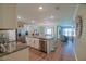 Open concept kitchen with granite countertops, stainless steel appliances, and adjacent dining area at 6933 Se 111Th Ln, Belleview, FL 34420
