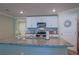 Spacious kitchen island with granite countertops and stainless steel sink complements the open layout at 6933 Se 111Th Ln, Belleview, FL 34420