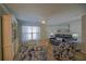 A living room includes hardwood floors, ceiling fan, and a decorative cabinet at 6933 Se 111Th Ln, Belleview, FL 34420
