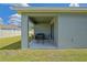 Covered patio with table and chairs for outdoor relaxation at 6933 Se 111Th Ln, Belleview, FL 34420