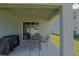 Covered patio with table and chairs for relaxed outdoor enjoyment at 6933 Se 111Th Ln, Belleview, FL 34420