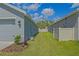 Spacious side yard with well-kept lawn and privacy fence between homes at 6933 Se 111Th Ln, Belleview, FL 34420
