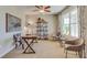 Bright home office with large window, desk, shelving, and neutral color scheme at 7109 Se 113Th Ln, Belleview, FL 34420