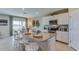 Bright kitchen featuring white cabinetry, granite countertops, and an island with seating at 7109 Se 113Th Ln, Belleview, FL 34420
