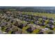 Panoramic aerial view of a tranquil neighborhood by a golf course, showcasing well-maintained homes and landscaping at 7283 Sw 94Th Ave, Ocala, FL 34481