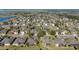 Overhead shot of a quiet residential area with well-kept lawns, mature trees, and houses with neutral color schemes at 7283 Sw 94Th Ave, Ocala, FL 34481