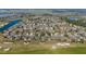 Community aerial view with houses, ponds, golf courses, trees, and green space at 7283 Sw 94Th Ave, Ocala, FL 34481