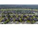 Aerial shot of a residential neighborhood next to a golf course, with well-kept homes and tree-lined streets at 7283 Sw 94Th Ave, Ocala, FL 34481
